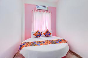 a bedroom with a large bed with a window at Via Pink House in Pune