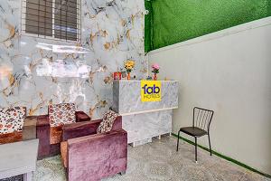 a living room with a couch and a chair at Via Pink House in Pune +19 photos