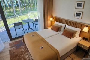 a hotel room with a large bed and a balcony at CLIFF Trzęsacz - sea view apartments in Trzęsacz +123 photos