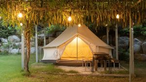 a tent with a table in front of it at Yangyang Slowstay Pension in Yangyang