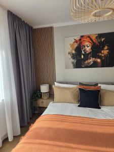 En eller flere senge i et værelse på ALiVA Stay Apartment