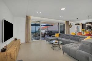 a living room with a couch and a television at Villa Bacula in Veliko Brdo