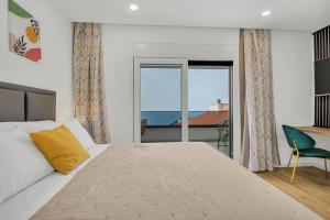 a bedroom with a bed and a view of the ocean at Villa Bacula in Veliko Brdo +37 photos
