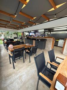 a patio with tables and chairs and a kitchen at Eva Apart Kemer in Kemer