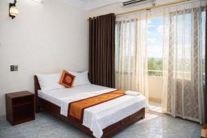 a bedroom with a bed and a large window at Phúc Lộc Hotel Ninh Bình in Ninh Binh +27 photos