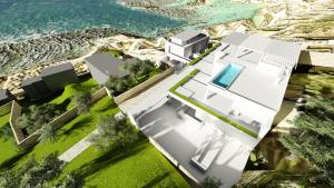 een luchtzicht op een wit huis naast de oceaan bij Fenici Levanzo Hotel - Adults Only in Levanzo