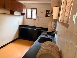 a small kitchen with a sink and a counter at Cheerful homes Mysore stay in Mysore +11 photos