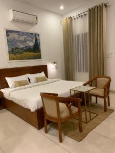 NārāyanpurThe Cub Sariska的一间卧室配有一张大床、椅子和一张沙发 更多8张照片