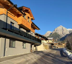 a building with a balcony on the side of a road at Apartment Winkl 65 in Maria Alm am Steinernen Meer