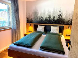 a bedroom with a bed with a painting on the wall at Apartment Winkl 65 in Maria Alm am Steinernen Meer