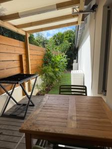 a wooden table and chairs on a patio at Bungalow Oana in Grande Saline