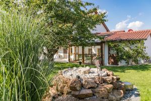 a garden with a fire pit in front of a house at Ferienwohnung Lex in Bad Griesbach