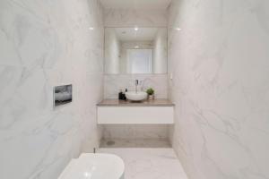 un bagno bianco con lavandino e WC di Lume Residence W a Setúbal Altre 20 foto