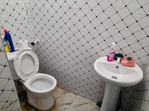a bathroom with a toilet and a sink at Mwembeni Abode in Bamburi