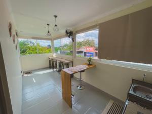 a kitchen with a table and chairs and a window at Avana Guesthouse in Kalasan