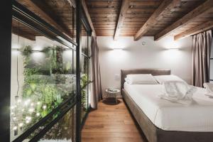 En eller flere senge i et værelse på Volta Luxury Collection