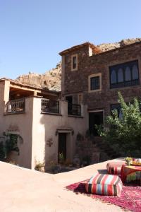 a stone house with two pillows in front of it at Dar Sihamou in Tabant