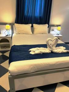 En eller flere senge i et værelse på Ali Baba Guest House