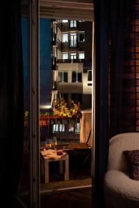 a room with a table and a view of a building at Balkan Charm - Private Parking in Belgrade