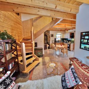 sala de estar con techos de madera y comedor en Górskie Siedlisko - 3 Chaty, en Rycerka Górna