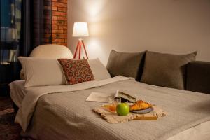 a tray of food on top of a bed at Balkan Charm - Private Parking in Belgrade