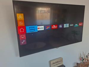 a flat screen tv hanging on a wall at Pension Fiete Celle in Celle