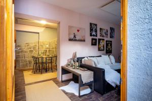 a living room with a couch and a table at Apartment Angel's Nest with Sauna and Fitness in Jesenice