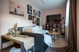 a living room with a couch and a table at Apartment Angel's Nest with Sauna and Fitness in Jesenice