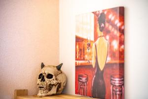 a skull sitting on a shelf next to a painting at Apartment Angel's Nest with Sauna and Fitness in Jesenice