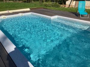 una piscina con acqua blu in un cortile di La maison de Laujol a Moissac