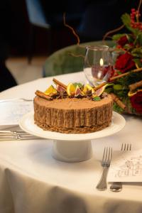 a chocolate cake on a white plate on a table at InterContinental Hotels Chantilly Chateau Mont Royal by IHG in Chantilly