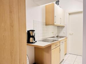 a kitchen with a sink and a coffee maker on a counter at Ferienwohnungen Weingut Breit in Piesport