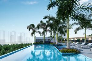 ein Swimmingpool mit Palmen auf einem Gebäude in der Unterkunft Taj Palace, Lucknow in Lucknow