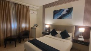 a hotel room with a bed and a desk at Jordan View Hotel in Amman