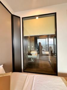 a bedroom with a large glass window with a view at Phương hotel Lyn Time Thanh Thuỷ in La Phu