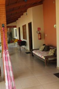 a room with two beds and a table and chairs at Pousada Jardim da Lagoa-BA in Bom Jesus da Lapa