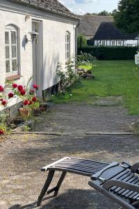 a bench sitting in front of a house at Davinde Bed & Breakfast in Odense