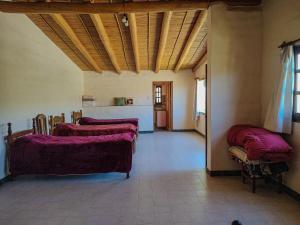 een woonkamer met twee bedden en een keuken bij Escalera de piedra 2 in Tilcara