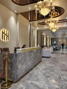 a woman sitting at a reception desk in a hotel lobby at Hotel Northern Heights in Amritsar