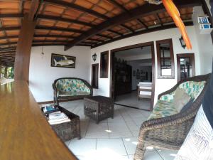 a living room with two chairs and a table at Pousada Agua Viva in Abraão