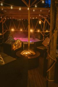 a room with a hot tub in a tent with lights at Evergreen -Ocean and Spa- in Parentis-en-Born +8 photos