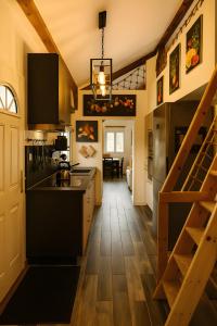 a kitchen with a staircase leading to a dining room at Evergreen -Ocean and Spa- in Parentis-en-Born