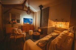 a bedroom with a bed and a tv in a room at Evergreen -Ocean and Spa- in Parentis-en-Born