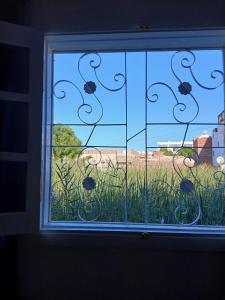 a window with a view of a field of grass at Villa Mena Luxor in Luxor +27 photos