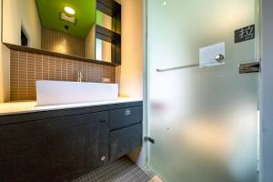 ein Badezimmer mit Waschbecken und Spiegel in der Unterkunft 懶懶小日子 in Hou-hou + 2 Fotos