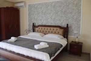 a bedroom with a large bed with towels on it at Hotel Kochana in Chʼkhorotsqu +26 photos