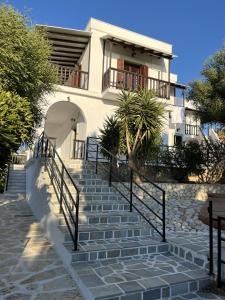 a house with stairs in front of it at Vivazoi Ousia studio # 3 in Leipsoi