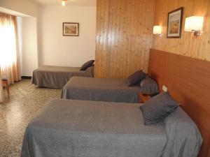 Postel nebo postele na pokoji v ubytování Hotel Jardín