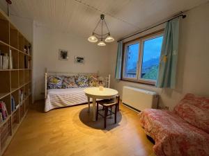 a bedroom with a table and a bed and a window at Ferienhaus Mauseloch in Kaub