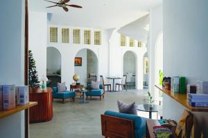 a living room with blue chairs and a table at Serenity Home in Siem Reap